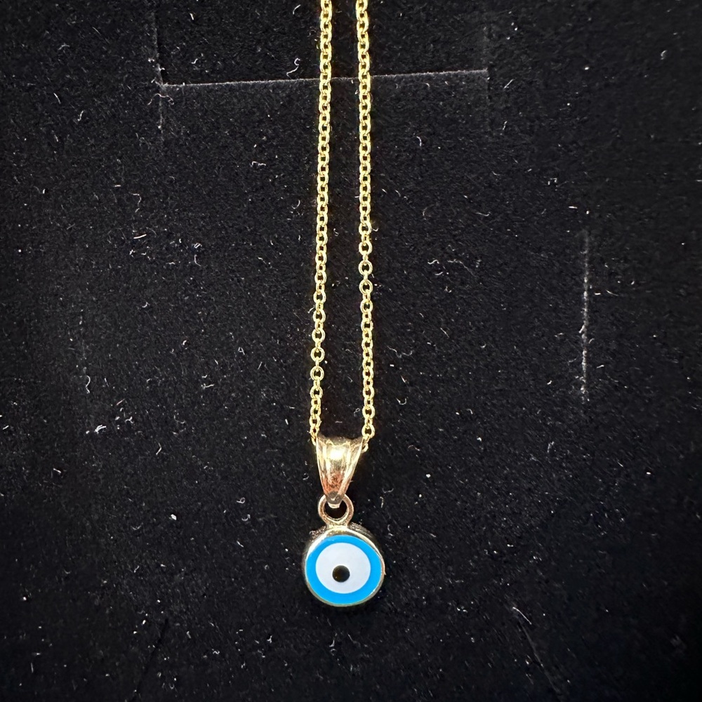 14k gold chain with Evil eye pendant. 14” inch length. Dainty piece of jewelry.